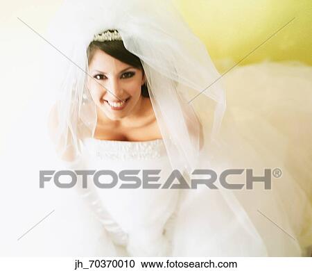 Portrait of a young woman wearing a bridal outfit smiling View Large Photo Image Stock Image - Portrait of a young woman wearing a bridal outfit smiling. Fotosearch