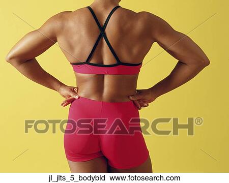 Stock Image - Rear view of a muscular young woman. Fotosearch