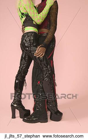 Picture - Side profile of a young couple hugging. Fotosearch