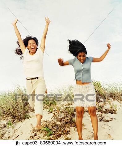 Two women jumping View Large Photo Image Picture - Two women jumping. Fotosearch