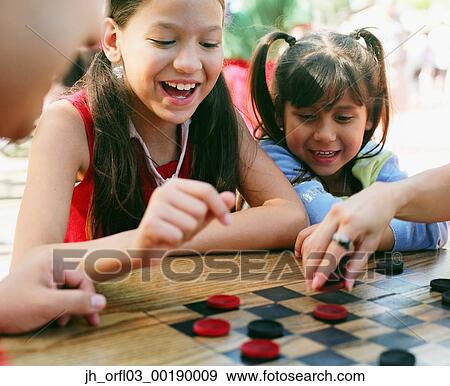 Two young girls playing checkers View Large Photo Image Stock Photo - Two young girls playing checkers. Fotosearch
