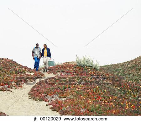 Stock Photo - Young couple walking down a path. Fotosearch