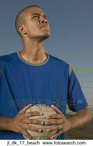 Young man holding a volleyball View Large Photo Image Stock Image - Young man holding a volleyball. Fotosearch