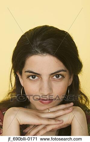 Stock Image - Young woman looking at camera. Fotosearch