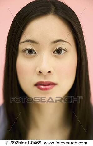 Young woman looking at camera View Large Photo Image Stock Photo - Young woman looking at camera. Fotosearch