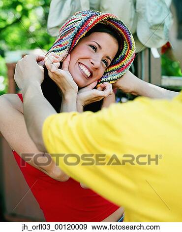 Young woman trying on scarf's View Large Photo Image Stock Photo - Young woman trying on scarf's. Fotosearch