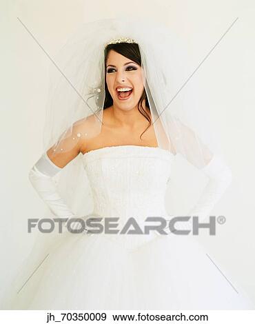 Young woman wearing a bridal outfit smiling View Large Photo Image Stock Photo - Young woman wearing a bridal outfit smiling. Fotosearch