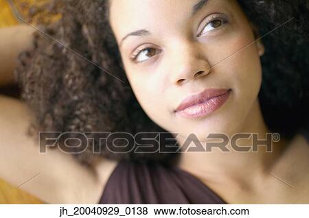 Close-up of a young woman looking up View Large Photo Image Stock Photo - Close-up of a young woman looking up. Fotosearch
