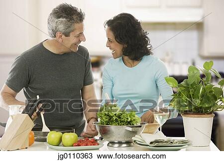 Couple looking at each other in the kitchen View Large Photo Image Stock Image - Couple looking at each other in the kitchen. Fotosearch