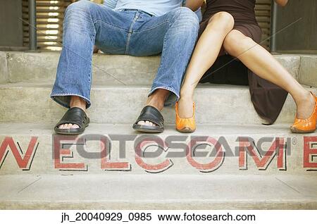 Feet of a couple sitting on steps View Large Photo Image Stock Photography - Feet of a couple sitting on steps. Fotosearch