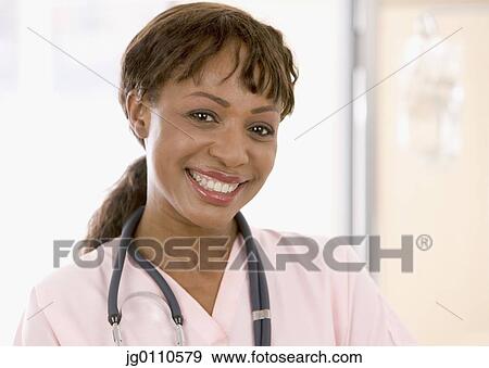 Stock Photo - Female medical personnel looking at camera smiling. Fotosearch