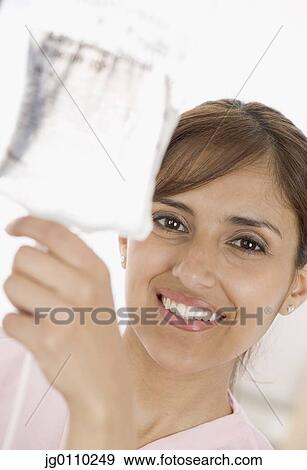 Stock Photo - Female nurse holding up an iv bag. Fotosearch