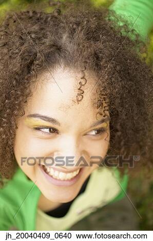 High angle view of a young woman smiling View Large Photo Image Stock Image - High angle view of a young woman smiling. Fotosearch