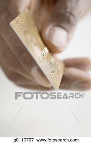 Human hand holding a credit card View Large Photo Image Stock Photo - Human hand holding a credit card. Fotosearch