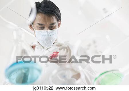 Stock Image - Male doctor testing in lab. Fotosearch