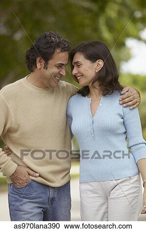 Mid adult couple standing close to each other View Large Photo Image Stock Image - Mid adult couple standing close to each other. Fotosearch