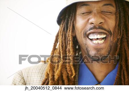 Mid adult man smiling with his eyes closed View Large Photo Image Picture - Mid adult man smiling with his eyes closed. Fotosearch