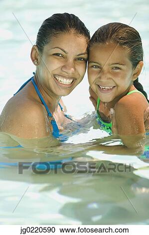 Mother and daughter in a swimming pool together View Large Photo Image Stock Image - Mother and daughter in a swimming pool together. Fotosearch