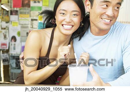 Portrait of a couple sitting together smiling View Large Photo Image Stock Photography - Portrait of a couple sitting together smiling. Fotosearch