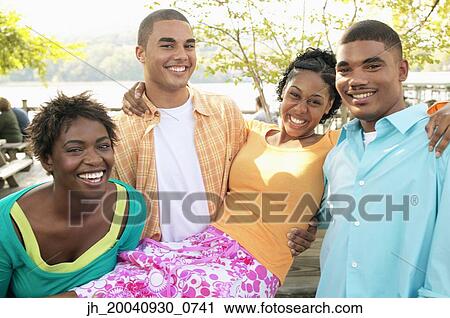 Portrait of a group of young people standing outdoors together View Large Photo Image Stock Image - Portrait of a group of young people standing outdoors together. Fotosearch
