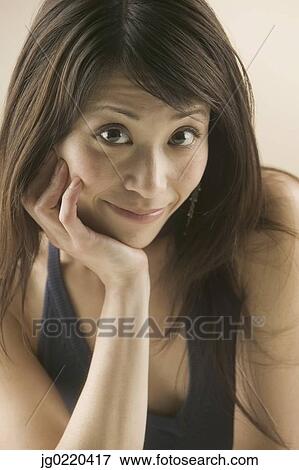 Stock Photo - Portrait of a woman smiling looking at camera. Fotosearch