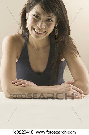 Stock Photo - Portrait of a woman smiling looking at camera. Fotosearch