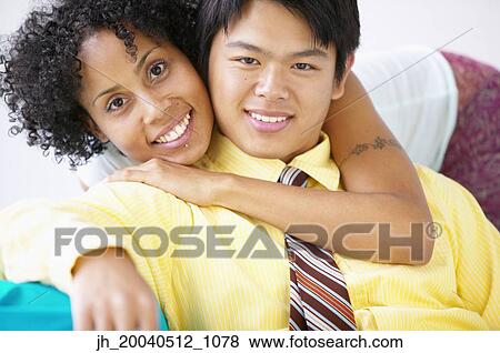 Portrait of a young couple smiling View Large Photo Image Stock Photo - Portrait of a young couple smiling. Fotosearch