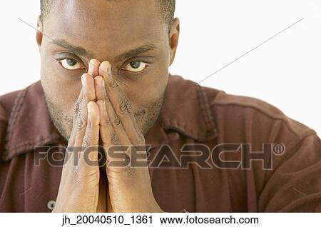 Portrait of a young man covering his nose with his hands View Large Photo Image Stock Image - Portrait of a young man covering his nose with his hands. Fotosearch