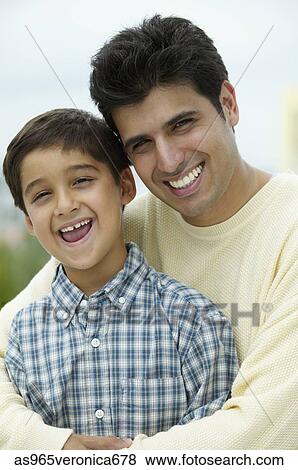 Portrait of a young man holding a young boy View Large Photo Image Stock Photo - Portrait of a young man holding a young boy. Fotosearch