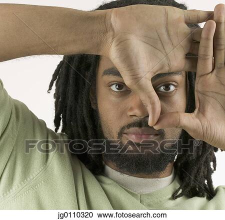 Portrait of a young man holding his hands up looking at camera View Large Photo Image Stock Image - Portrait of a young man holding his hands up looking at camera. Fotosearch