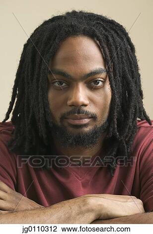 Portrait of a young man looking at camera View Large Photo Image Stock Image - Portrait of a young man looking at camera. Fotosearch