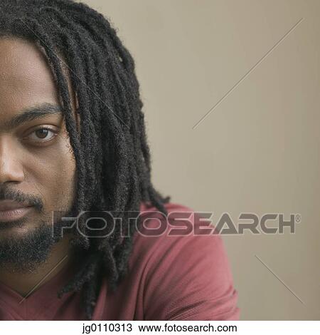 Portrait of a young man looking at camera View Large Photo Image Stock Image - Portrait of a young man looking at camera. Fotosearch