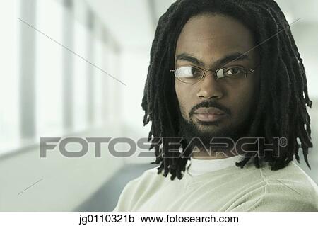 Portrait of a young man looking at camera View Large Photo Image Stock Image - Portrait of a young man looking at camera. Fotosearch