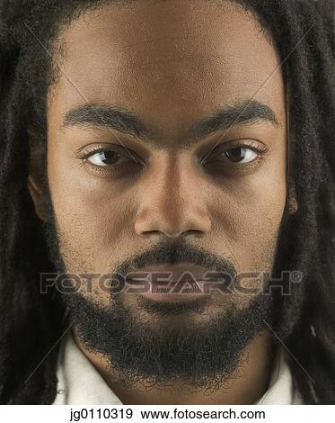 Portrait of a young man looking at camera View Large Photo Image Stock Photo - Portrait of a young man looking at camera. Fotosearch
