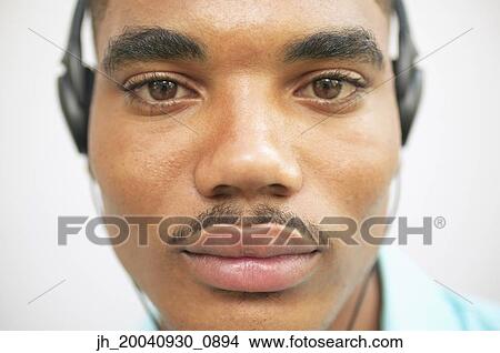 Portrait of a young man wearing headphones View Large Photo Image Picture - Portrait of a young man wearing headphones. Fotosearch