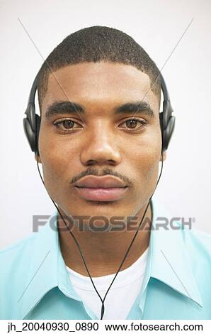 Portrait of a young man wearing headphones View Large Photo Image Stock Image - Portrait of a young man wearing headphones. Fotosearch