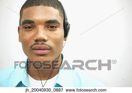 Portrait of a young man wearing headphones View Large Photo Image Stock Photo - Portrait of a young man wearing headphones. Fotosearch
