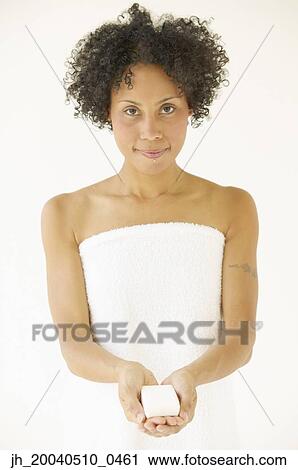 Stock Image - Portrait of a young woman holding cards. Fotosearch