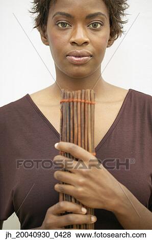 Portrait of a young woman holding incense sticks View Large Photo Image Stock Photo - Portrait of a young woman holding incense sticks. Fotosearch
