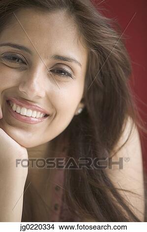 Portrait of a young woman looking at camera smiling View Large Photo Image Picture - Portrait of a young woman looking at camera smiling. Fotosearch
