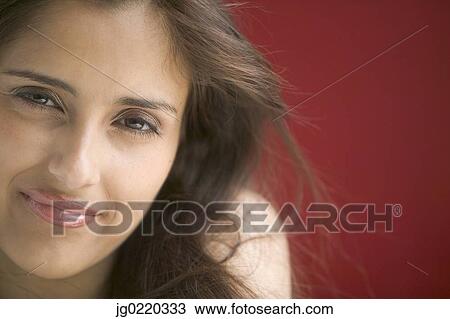 Portrait of a young woman looking at camera smiling View Large Photo Image Stock Image - Portrait of a young woman looking at camera smiling. Fotosearch