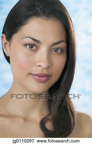 Portrait of a young woman looking at camera View Large Photo Image Stock Photo - Portrait of a young woman looking at camera. Fotosearch