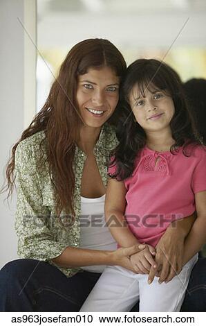 Portrait of a young woman sitting with a young girl View Large Photo Image Stock Image - Portrait of a young woman sitting with a young girl. Fotosearch