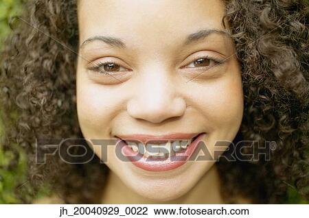 Portrait of a young woman smiling View Large Photo Image Stock Image - Portrait of a young woman smiling. Fotosearch