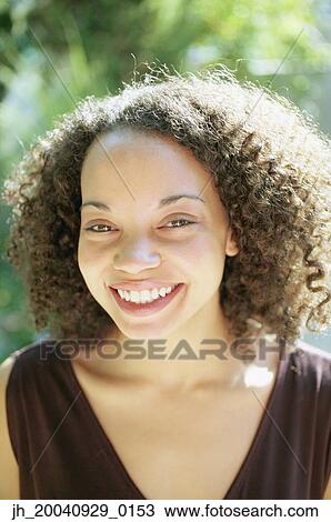 Portrait of a young woman smiling View Large Photo Image Stock Image - Portrait of a young woman smiling. Fotosearch