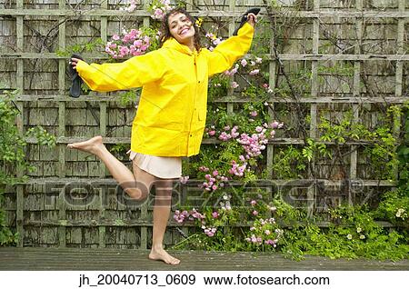 Portrait of a young woman standing against a wall View Large Photo Image Stock Photo - Portrait of a young woman standing against a wall. Fotosearch