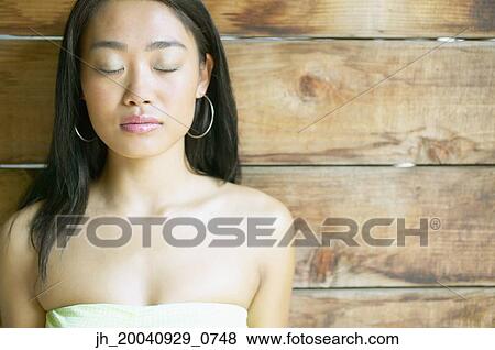 Portrait of a young woman with her eyes closed View Large Photo Image Stock Photo - Portrait of a young woman with her eyes closed. Fotosearch