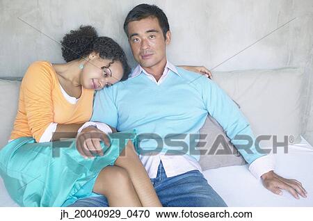 Portrait of mid adult man sitting with a young woman View Large Photo Image Stock Image - Portrait of mid adult man sitting with a young woman. Fotosearch