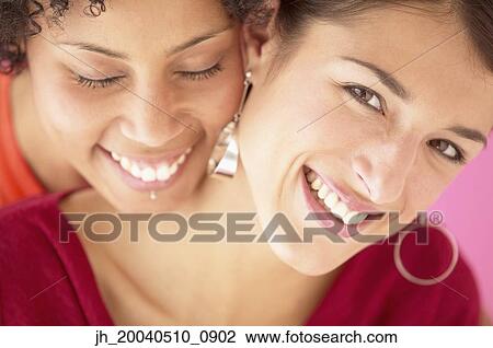 Portrait of two young women smiling View Large Photo Image Stock Image - Portrait of two young women smiling. Fotosearch