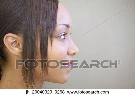 Side profile of a young woman View Large Photo Image Stock Photo - Side profile of a young woman. Fotosearch